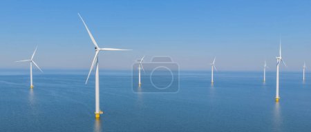 Photo for Windmill Park with windmill turbines and a blue sky , windmill turbines park in the ocean. Netherlands Europe the biggest wind park in the Netherlands - Royalty Free Image