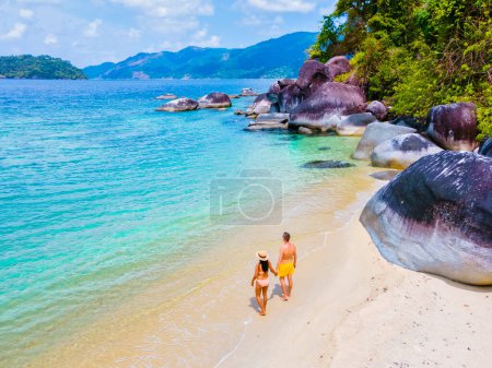 Photo for Koh Adang Island Southern Thailand, a couple of men and women on the beach with a turqouse colored ocean. - Royalty Free Image