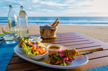 Photo for Thai food on a table on the beach in Thailand. table with Thai food Thai sate - Royalty Free Image