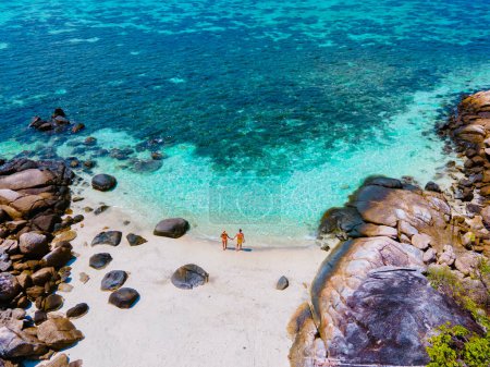 Téléchargez les photos : Kla Island Koh Lipe Thaïlande est une petite île sur la côte de Ko Lipe avec un récif corallien et un grand lieu de plongée avec tuba, couple hommes et femmes sur la plage vue sur drone - en image libre de droit