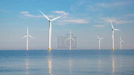 Photo for Windmill Park with a blue sky windmill turbines park in the ocean. Netherlands Europe the biggest wind park in the Netherlands - Royalty Free Image