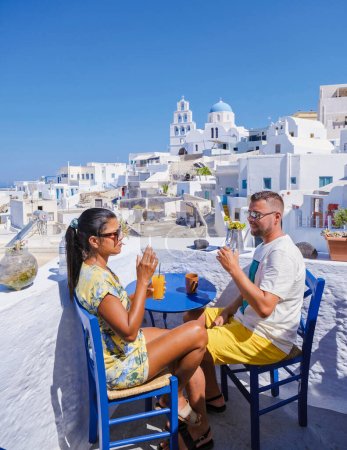 Photo for Couple on vacation in Santorini Greece, men and women visit the whitewashed Greek village Pyrgos Santorini - Royalty Free Image