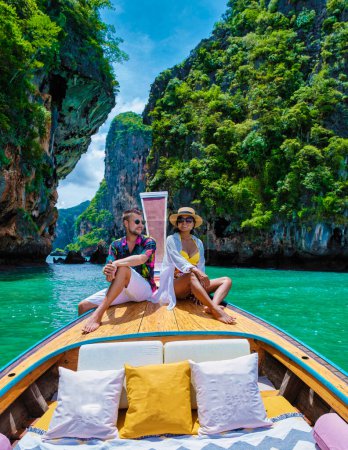 Photo for Luxury Longtail boat in Krabi Thailand, couple man, and woman on a trip at the tropical island 4 Island trip in Krabi Thailand. Asian woman and European man mid age on vacation in Thailand. - Royalty Free Image