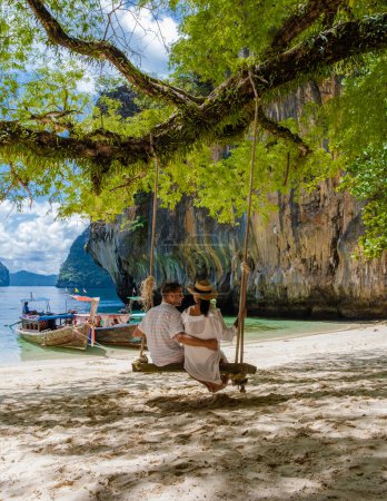 Photo for Couple on a boat trip to the Tropical lagoon of Koh Loa Lading Krabi Thailand part of the Koh Hong Islands in Thailand. beautiful beach with limestone cliffs and longtail boats - Royalty Free Image