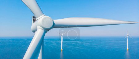 Photo for Windmill Park with a blue sky close up of windmill turbines at sea - Royalty Free Image