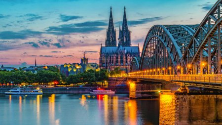 Foto de Cologne Koln Germany during sunset, Cologne bridge with the cathedral. beautiful sunset at the Rhine river - Imagen libre de derechos
