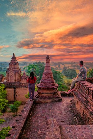 Photo for Bagan Myanmar, Sunrise above temples and pagodas of Bagan Myanmar, Sunrise Pagan Myanmar temple and pagoda. Men and woman at an old pagoda - Royalty Free Image