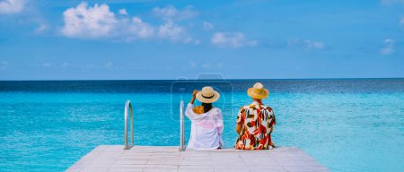 a couple visit Playa Porto Marie beach Curacao, white tropical beach with turqouse water ocean, couple men and women on vacation in Curacao