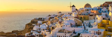 Photo for White churches and blue domes by the ocean of Oia Santorini Greece, a traditional Greek village in Santorini in the evening light - Royalty Free Image
