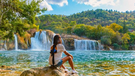 Photo for KRKA waterfalls Croatia during summer, young Asian women watch the waterfalls of krka national park Croatia on a bright summer evening in the park. - Royalty Free Image