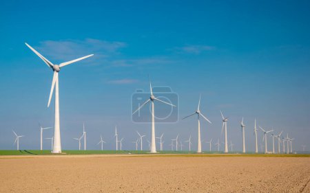 Photo for Offshore windmill park with clouds and a blue sky, windmill park in the ocean aerial view with wind turbine Flevoland Netherlands Ijsselmeer. Green energy - Royalty Free Image