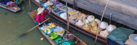 Photo for Market stall holders in small boats selling local fruits and vegetables, Damnoen Saduak Floating Market, Thailand - Royalty Free Image