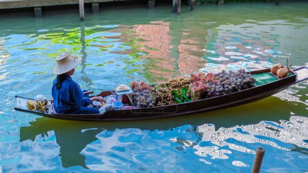 Photo for August 2023, market stall holders in small boats selling local fruits and vegetables, Damnoen Saduak Floating Market, Thailand - Royalty Free Image