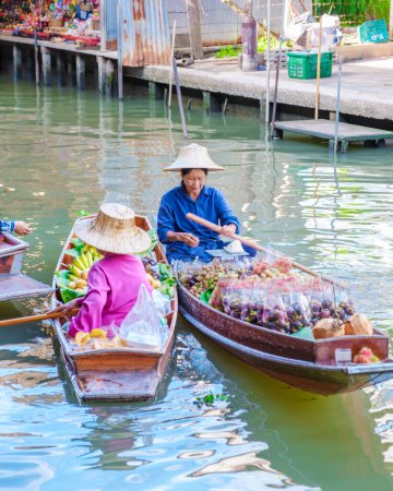 Photo for Bangkok Ratchaburi Thailand August 2023, market stall holders in small boats selling local fruits and vegetables, Damnoen Saduak Floating Market, Thailand - Royalty Free Image