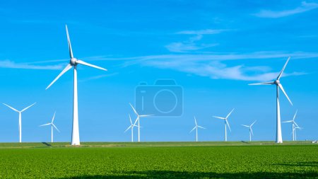 Photo for Offshore Windmill farm in the ocean Westermeerwind park, windmills isolated at sea on a beautiful bright day Netherlands Flevoland Noordoostpolder. Huge windmill turbines - Royalty Free Image