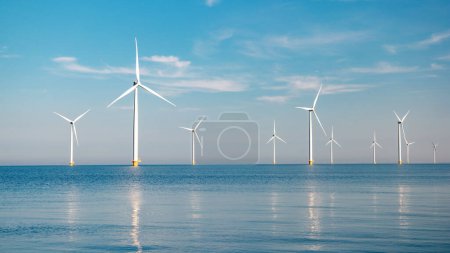 Photo for Offshore windmill park alternative energy. windmills in the sea with reflection in the morning in the Netherlands - Royalty Free Image