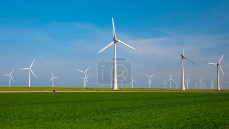 Photo for Windmills for electric power - Energy Production with clean and Renewable Energy - aerial drone shot - Royalty Free Image