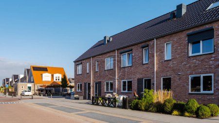 Photo for Dutch Suburban area with modern family houses, Modern Street with Terraced Real Estate for Families in the Netherlands - Royalty Free Image