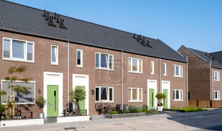 Photo for Dutch Suburban area with modern family houses, newly build modern family homes in the Netherlands, dutch family house in the Netherlands, Street with modern family houses in urban suburb - Royalty Free Image