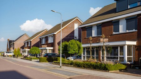 Photo for Dutch Suburban area with modern family houses, newly built modern family homes in the Netherlands, family houses in the Netherlands, Row of modern houses in a family friendly suburban neighborhood - Royalty Free Image