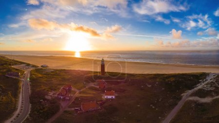 Photo for Drone aerial view at the Texell lighthouse during sunset Netherlands Dutch Island Texel in summer with sand dunes at the Wadden Island - Royalty Free Image