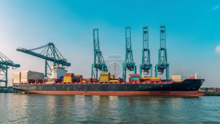 Photo for Antwerp, Belgium, view of harbor cranes and container ships in the largest dock of the port of Antwerp. Huge container vessel in the harbor with containers - Royalty Free Image