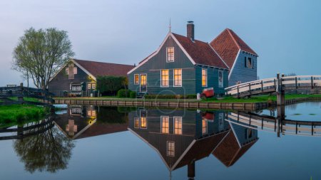 Photo for Sunset at the windmill village Zaanse Schans during Spring in the Netherlands Holland village with historical wooden farms at sunset - Royalty Free Image