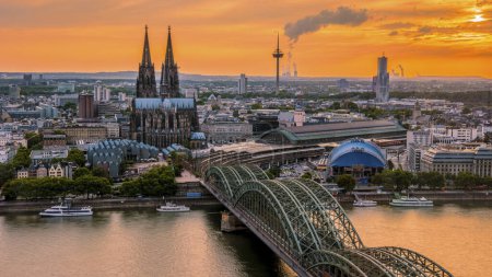 Foto de Cologne Koln Germany during sunset, Cologne bridge with the cathedral. beautiful sunset at the Rhine river - Imagen libre de derechos