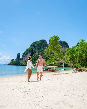 Photo for Koh Phakbia Island is near Koh Hong Krabi, a beautiful white sandy beach in Krabi Thailand. Young Asian women and European men on the beach during a vacation in Thailand. - Royalty Free Image