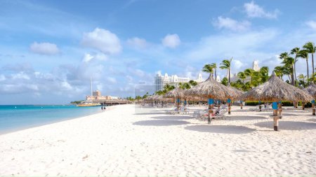 Photo for Palm Beach Aruba Caribbean, white long sandy beach with palm trees at Aruba Antilles. - Royalty Free Image