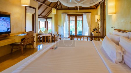 Photo for Bedroom Interior of a modern house with a swimming pool, modern pool villa at the beach, indoor view of a uxury villa in Thailand - Royalty Free Image