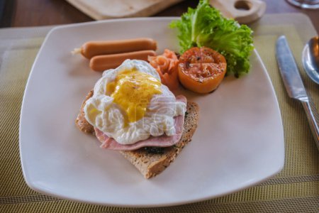 Photo for Poached egg during breakfast table on the beach of Koh Kood in Thailand,egg benedict breakfast table at a luxury hotel - Royalty Free Image