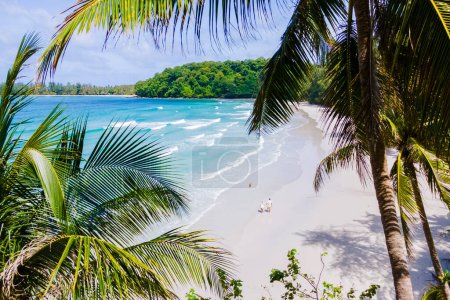 Ao Jark Bay et plage Koh Kood Island Thaïlande Trat, plage tropicale avec palmiers et turquoise couleur océan par une journée ensoleillée, couple marchant sur la plage vue d'en haut avec drone entre les palmiers