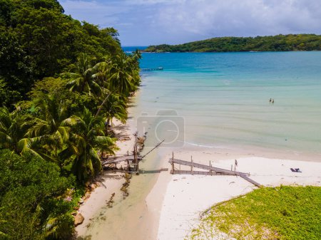 Photo for Wooden bridge at Bang Bao Beach Koh Kood Island Thailand Trat , tropical beach with palm trees and a turqouse colored ocean on a sunny day, Ko Kut Island with coconut palm trees on the beach, - Royalty Free Image