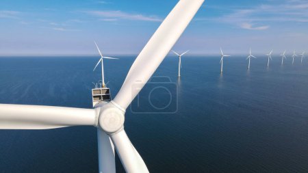 Foto de Vista de cerca en el parque del molino de viento con un cielo azul, Parque del molino de viento en la vista aérea del océano con turbina eólica Flevoland Países Bajos Ijsselmeer. Producción de energía verde en los Países Bajos - Imagen libre de derechos