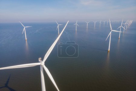 close up the ocean Wind Farm turbines. Windmill farm in the ocean. Offshore wind turbines in the sea. Wind turbine from an aerial view,