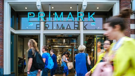 Photo for Amsterdam Netherlands 22 June 2017, Damrak shopping street on a busy weekend day, Primark sign in front of shopping store - Royalty Free Image
