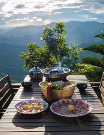 Photo for Dinner with a Thai BBQ at sunset in the mountains of Doi Chang Chiang Rai Thailand - Royalty Free Image