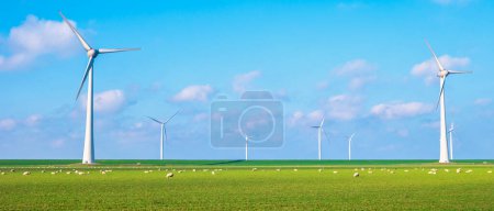 Photo for Windmill park on land, energy transition windmill turbines generating green energy, windmills isolated at sea in the Netherlands. - Royalty Free Image