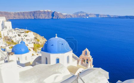 Foto de Oia Santorini Grecia en un día soleado durante el verano con casas e iglesias encaladas, islas griegas del Egeo Cícladas en un día soleado con el océano azul en las calles de Santorini - Imagen libre de derechos
