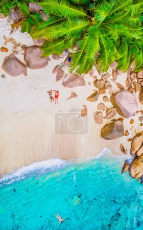 Photo for Drone view from above at Anse Lazio Beach Praslin Island Seychelles. A couple of men and women on the beach relaxing during a vacation in Seychelles - Royalty Free Image