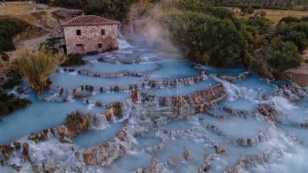 Toscane Italy, natural spa with hot springs waterfalls at Saturnia thermal Baths, Grosseto, Tuscany, Italy aerial view on the Natural thermal waterfalls couple at vacation at Saturnia Tuscany