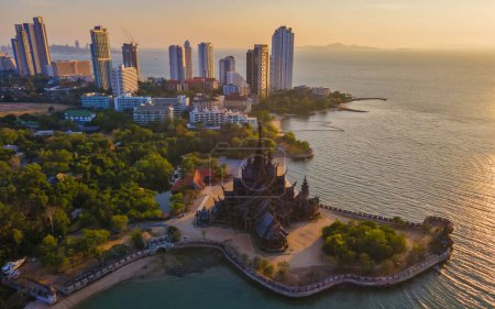 Photo for Sanctuary of Truth, Pattaya, Thailand, wooden temple by the ocean during sunset on the beach of Pattaya Chonburi Thailand. Skyline of Pattaya - Royalty Free Image