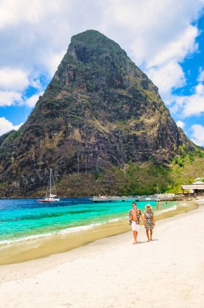Photo for Young couple men and women on vacation in Saint Lucia, luxury holiday Saint Lucia Caribbean, diverse couple walking at Sugar Beach - Royalty Free Image