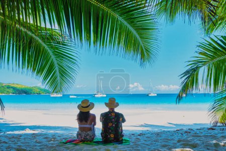 Photo for Anse Lazio Beach Praslin Seychelles, a young couple of men and women on a tropical beach during a luxury vacation in Seychelles. - Royalty Free Image