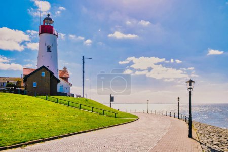 sunset at the lighthouse and harbor of Urk Holland. Fishing village Urk. Beautiful sunset during the evening in Urk Flevoland Netherlands Europe