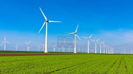 Photo for Windmill turbines with blue sky, windmill turbines on land and in the ocean Netherlands Europe - Royalty Free Image