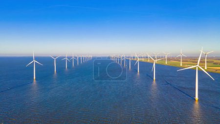 Photo for Windmill turbines Park with a blue sky, and windmill turbines in the ocean, biggest wind park in the Netherlands - Royalty Free Image
