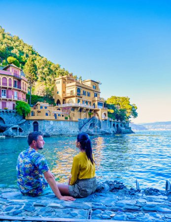 Photo for Beautiful sea coast with colorful houses in Portofino Italy Europe Portofino in Liguria Genoa Couple mid age man and woman visiting Italy during a vacation in the summer - Royalty Free Image