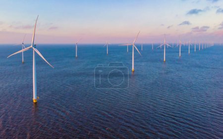 Photo for Windmill turbines in the Netherlands at sea, green energy transition in Europe - Royalty Free Image